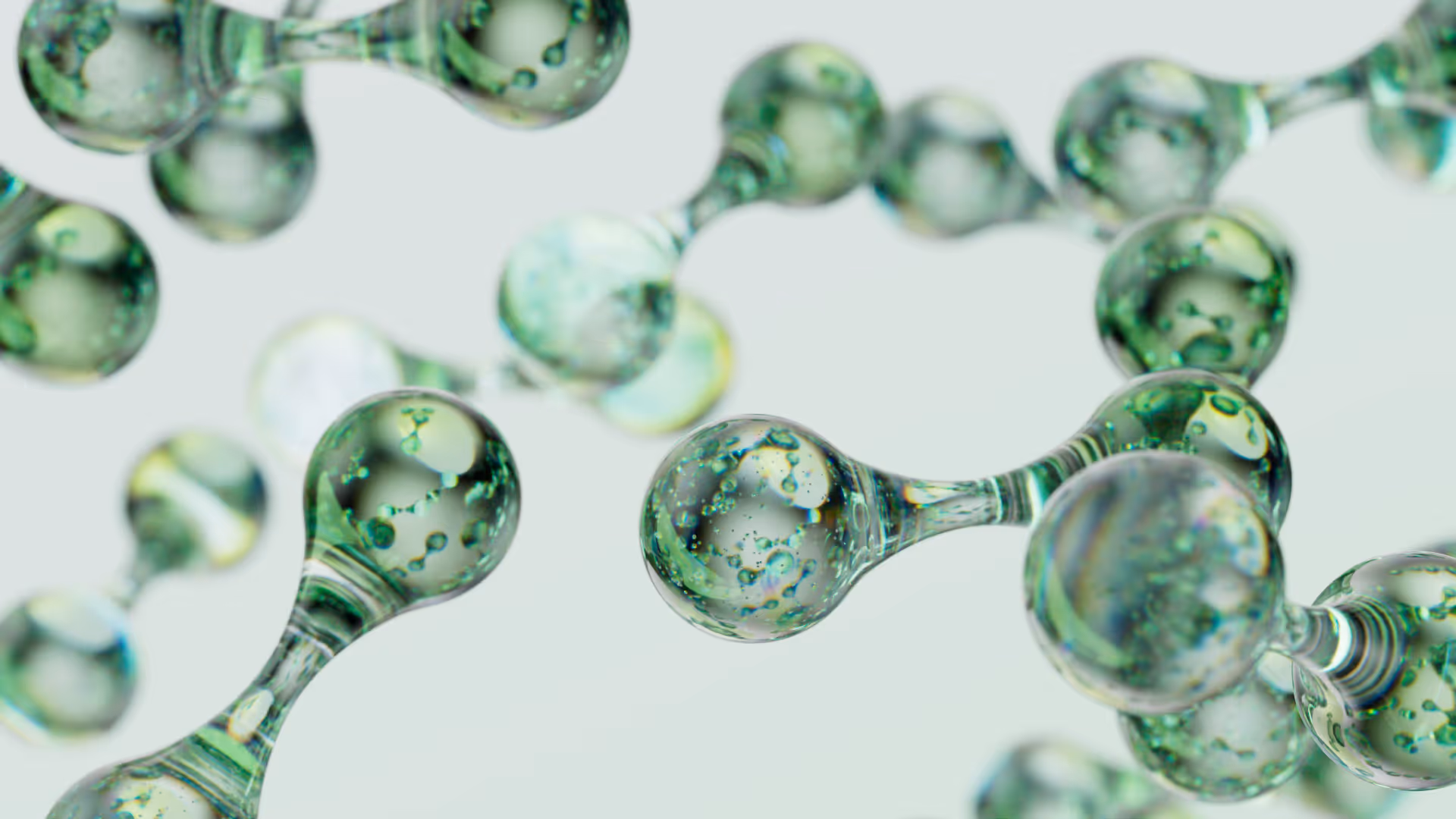 Close-up of translucent green molecular structures connected by thin links on a light background.
