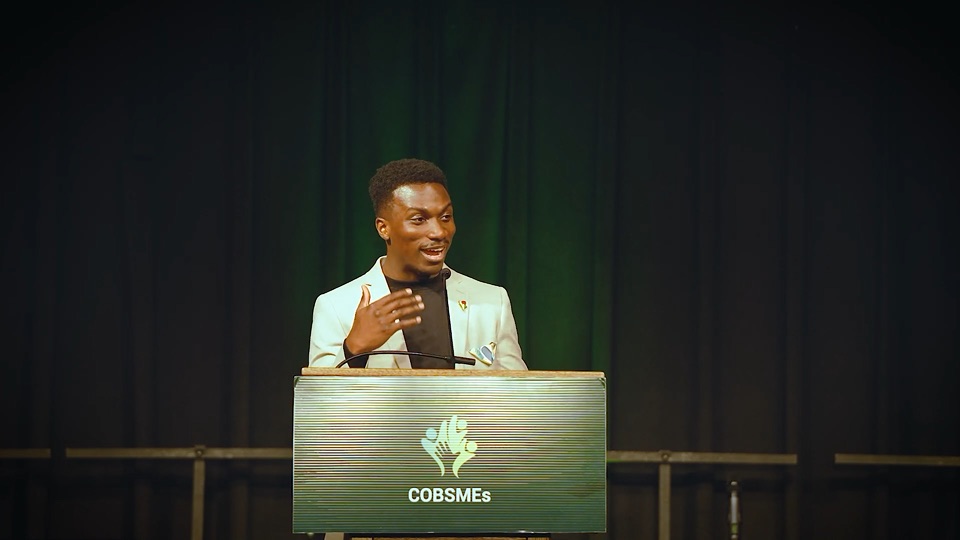 David Akinmade mid-sentence at the Coalition of Black SMEs lectern