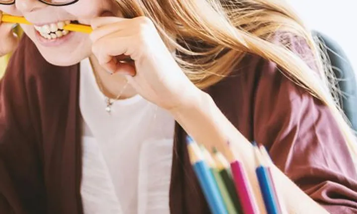 Empty daily planner page for Tuesday with hourly time slots and sections for goals and to-do list inside a black wire basket.