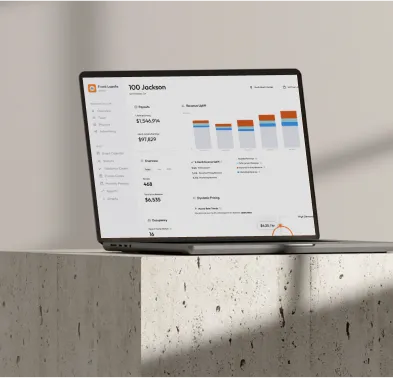 Laptop on stone table showing a finance dashboard with charts and financial metrics named 100 Jackson.