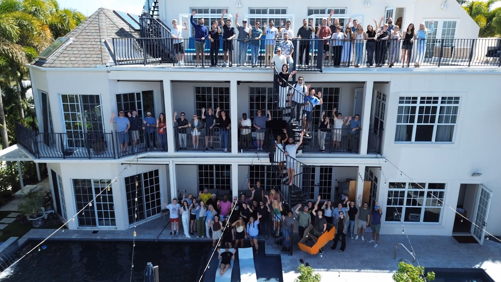 AirGarage team gathered on the balconies of a waterfront house during a company retreat