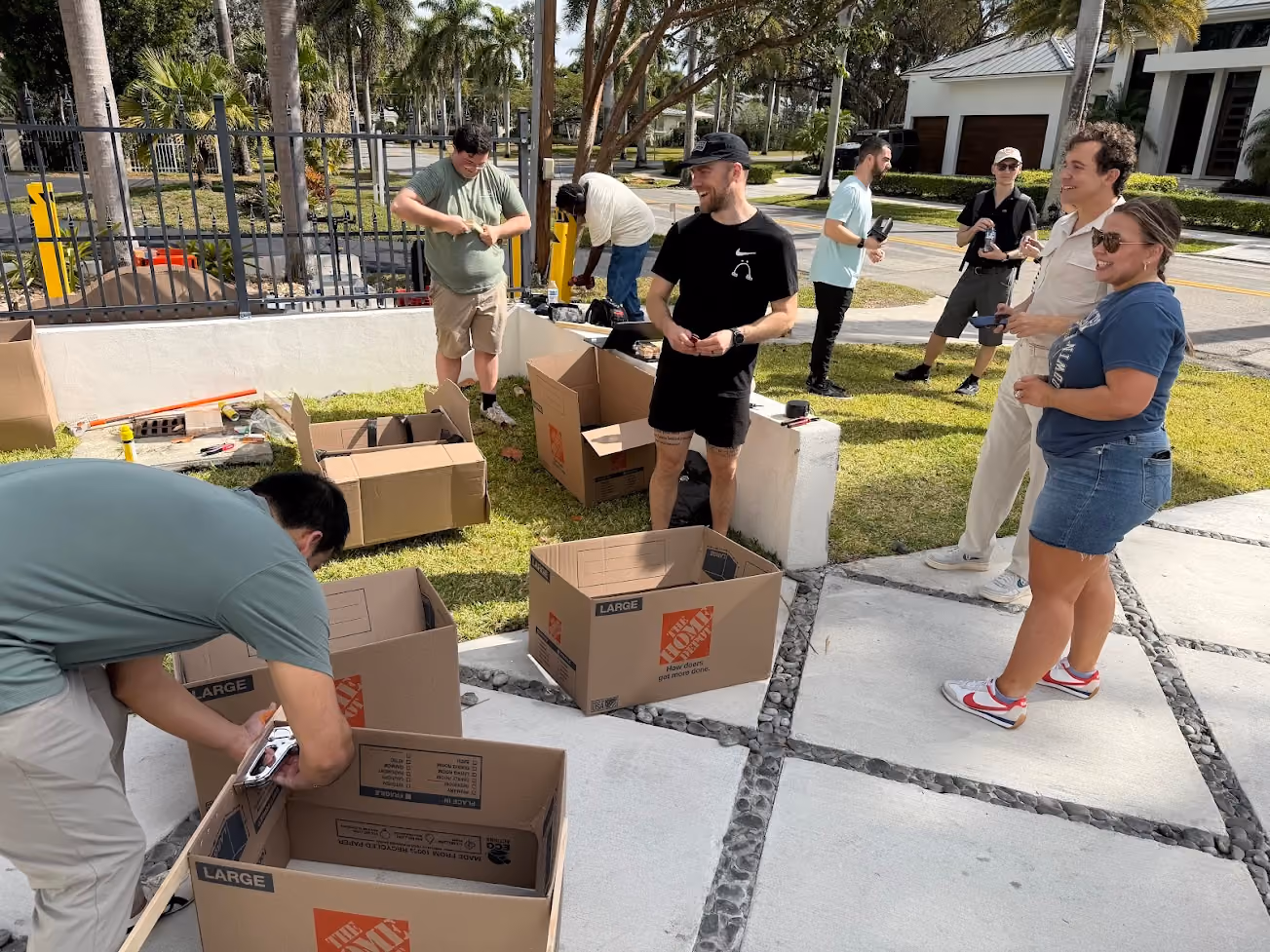 AirGarage team members assembling cardboard boxes together outdoors