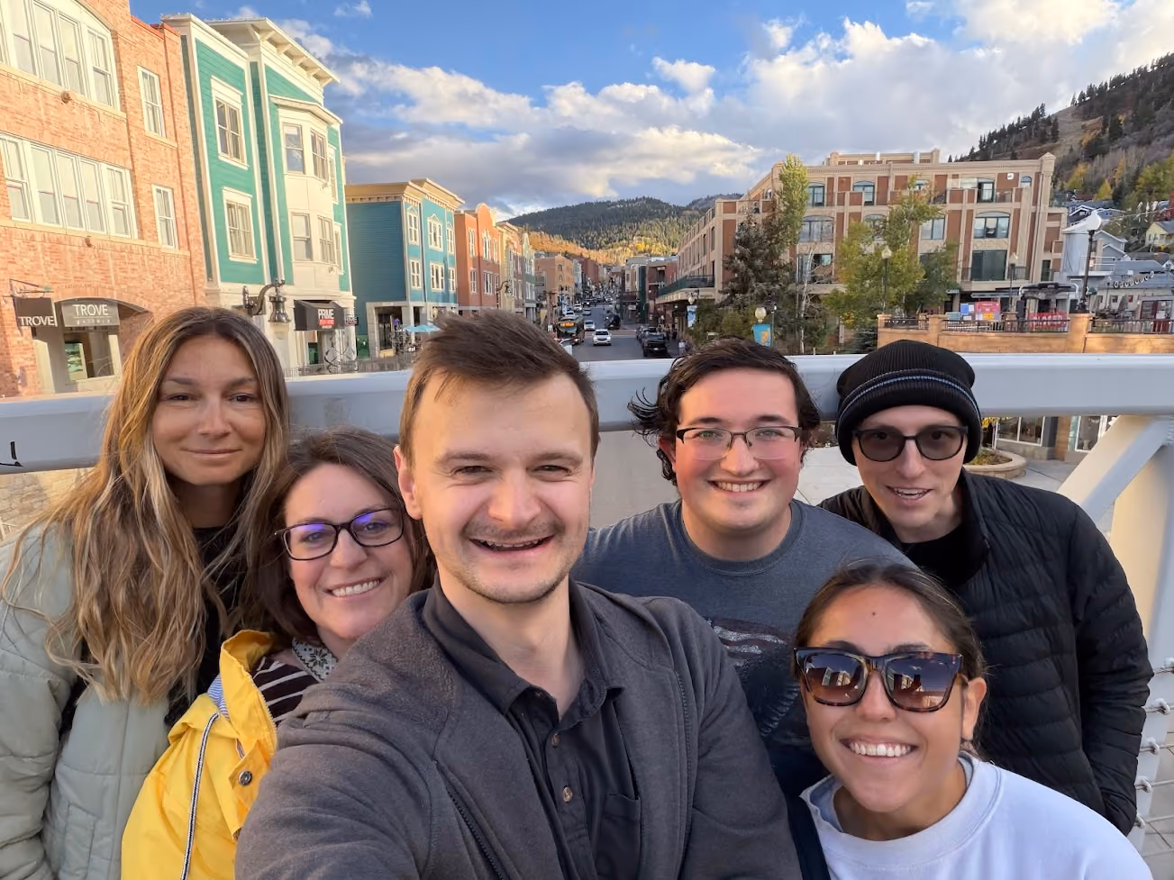 AirGarage team members taking a selfie on a bridge in a mountain town