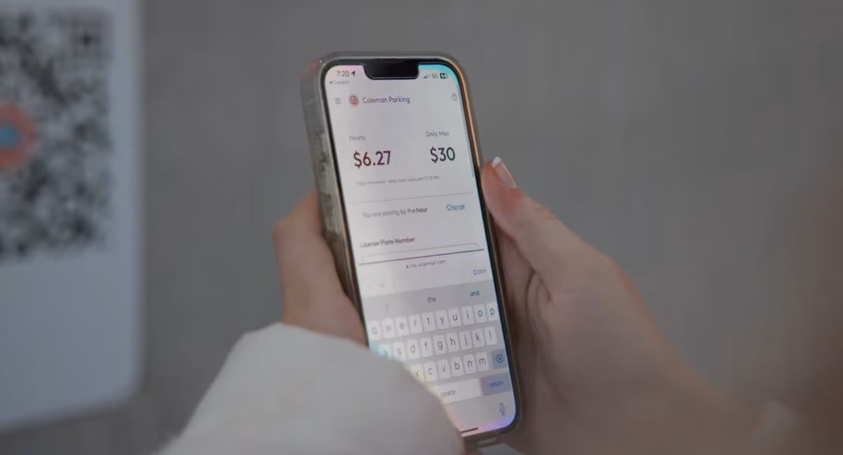 Person using a mobile phone to pay for parking through the AirGarage app