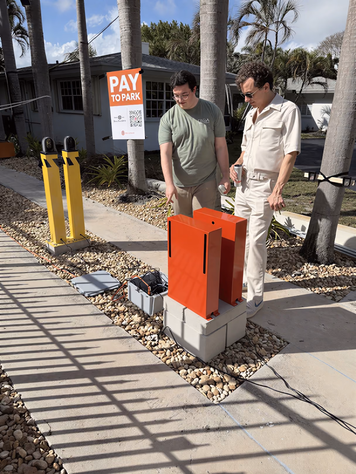 AirGarage team members installing parking payment equipment on-site