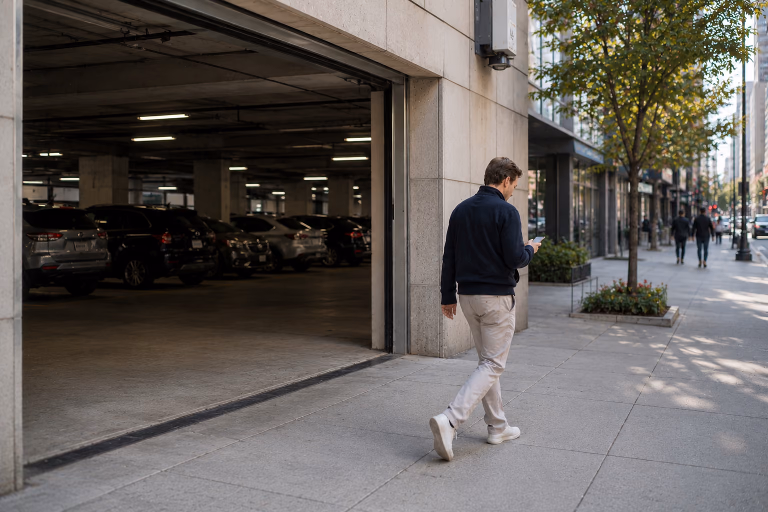 Driver leaving a parking garage with phone in hand