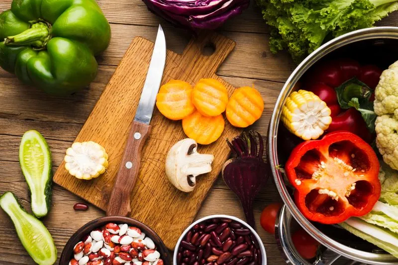 A cutting board topped with lots of vegetables.