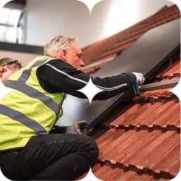 Worker installing rooftop solar panels as part of green skills and employment training.