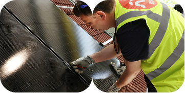 Worker installing rooftop solar panels as part of green skills and employment training.