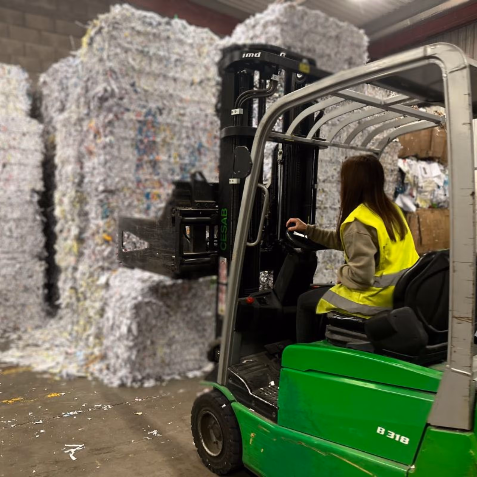ELITE Paper Solutions employee operating machinery in a supported employment workplace.