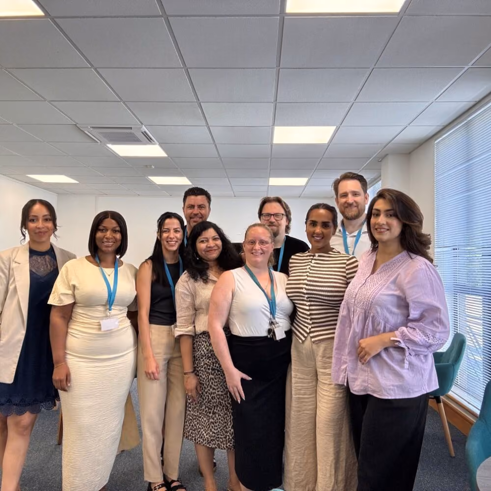 Ten Fedcap colleagues pose together in an office.