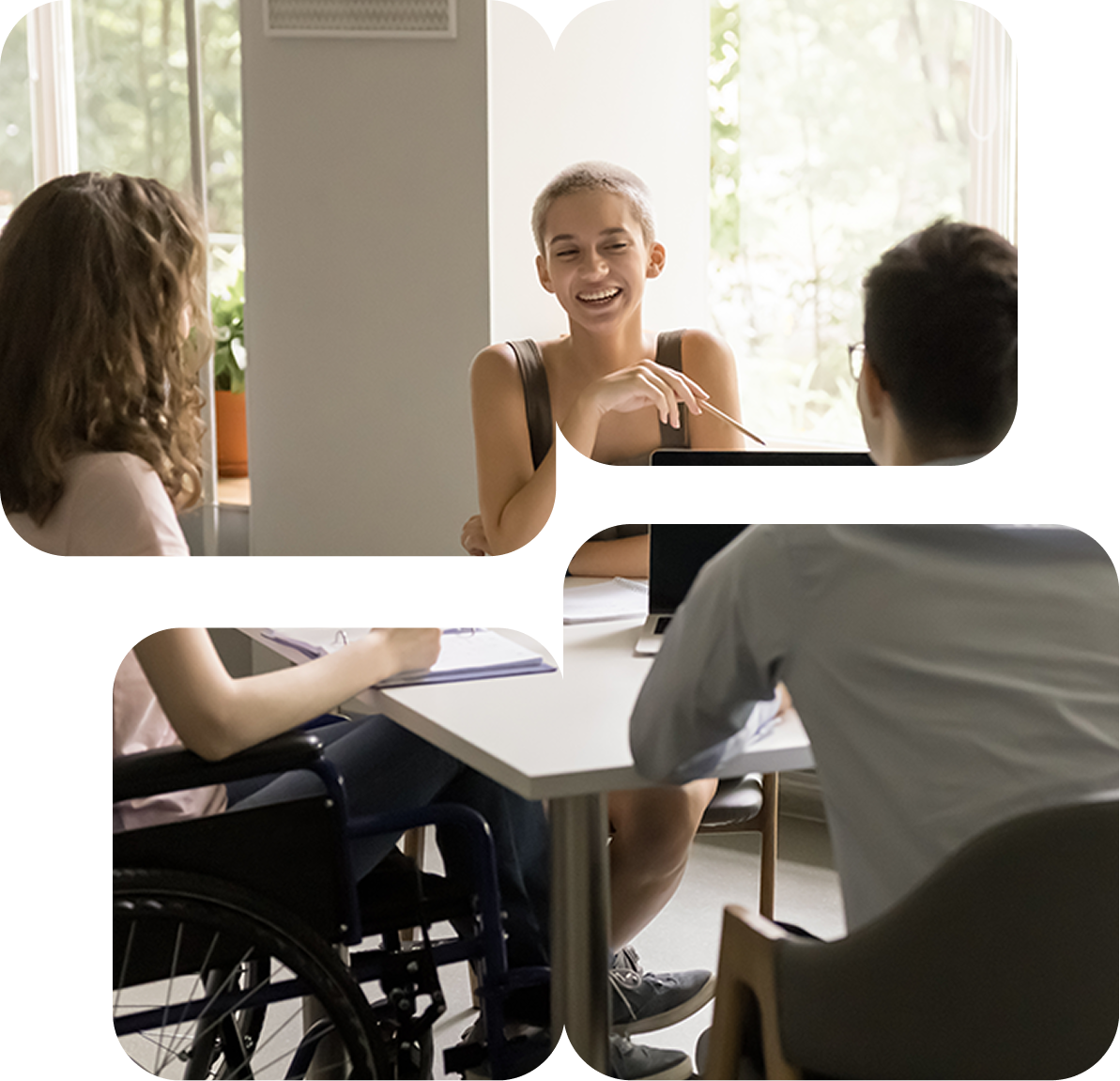 Three people sit around a table talking, including a person in a wheelchair.