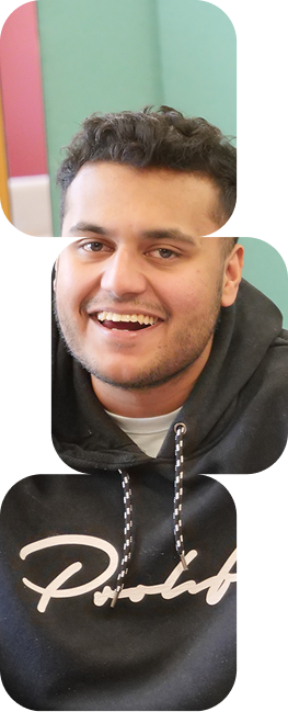Smiling young man in a black hooded sweatshirt.