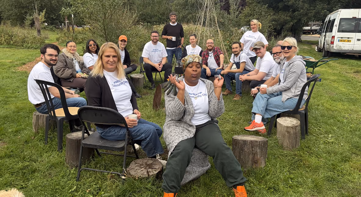 A group of Fedcap Community Day workers sitting around a campfire