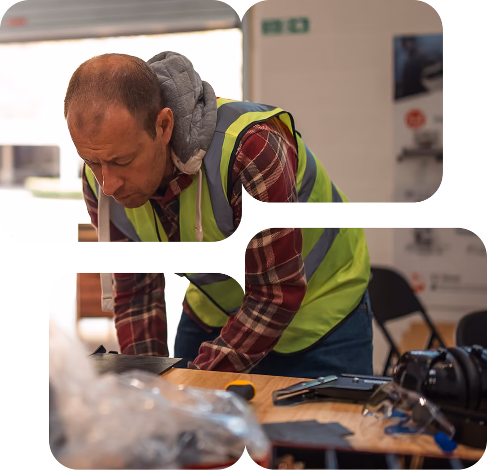 A man in a hazard vest at a tool bench in a workforce development program