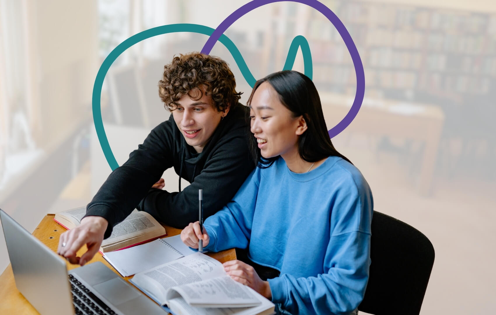 Two young people sit together in a library, smiling as they look at a laptop screen.