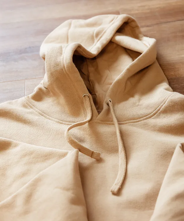 Beige hoodie on wood background