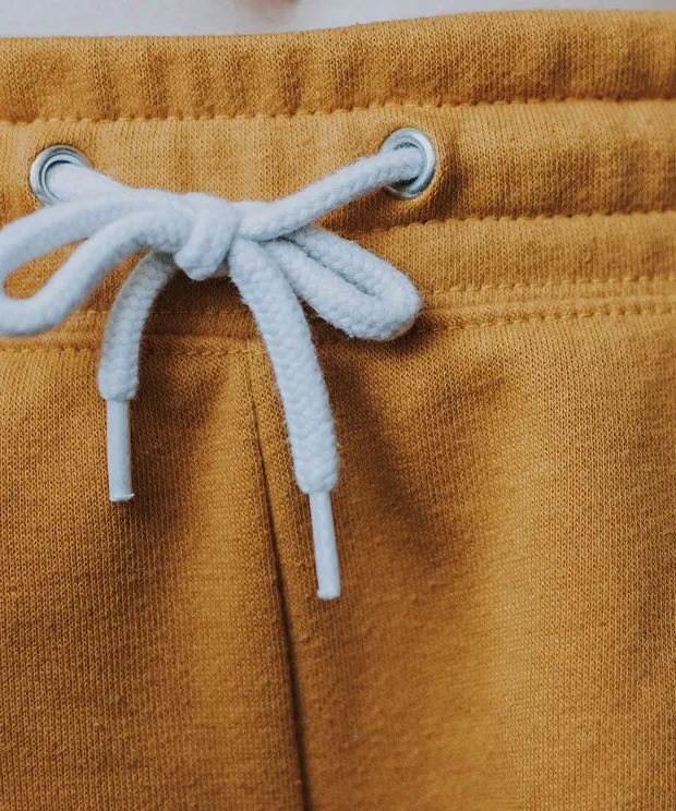 Orange cotton shorts close up on waist