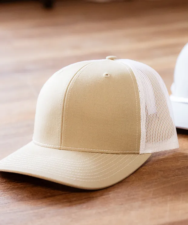 Beige trucker hat on a wood background