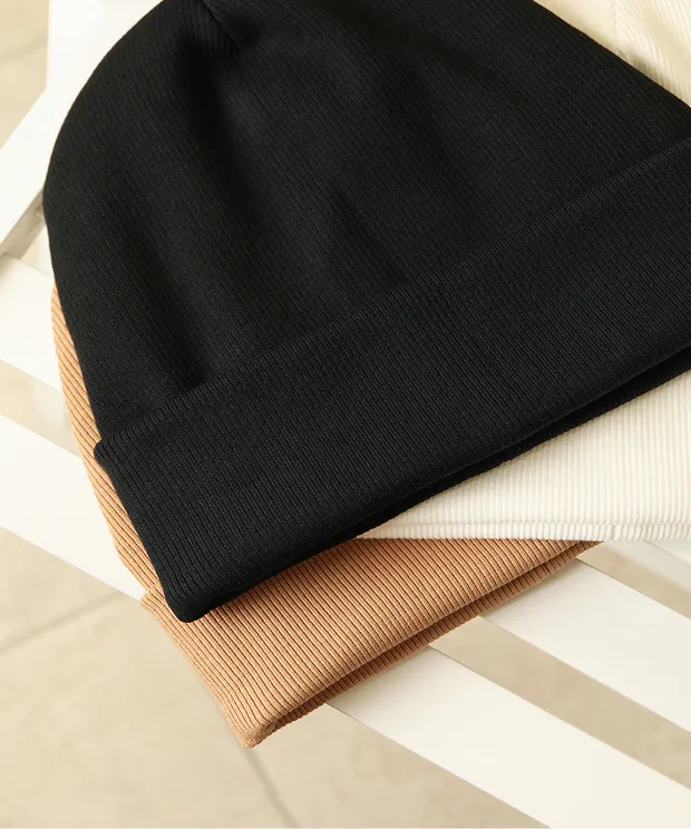 Three beanies on a chair