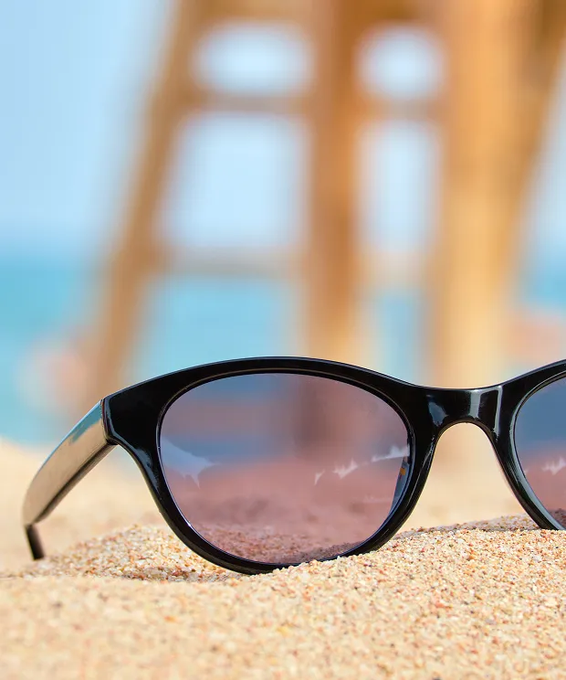 Sunglasses in the sand at the beach