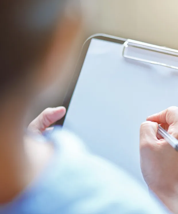 Image of person holding a clipboard