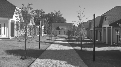 Black and white aerial sketch of a residential neighborhood with modern apartment buildings and houses surrounded by trees.