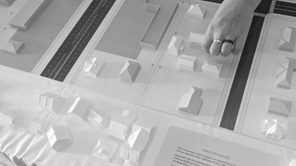 Black and white aerial sketch of a residential neighborhood with modern apartment buildings and houses surrounded by trees.