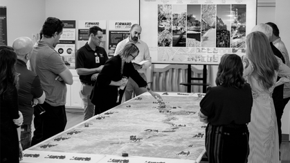 Black and white aerial sketch of a residential neighborhood with modern apartment buildings and houses surrounded by trees.