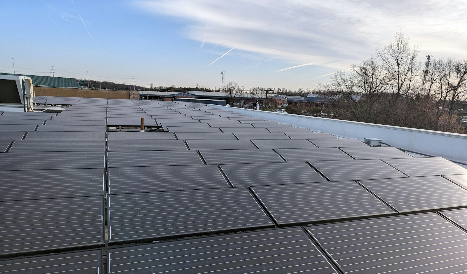 Commercial building roof covered with rows of solar panels