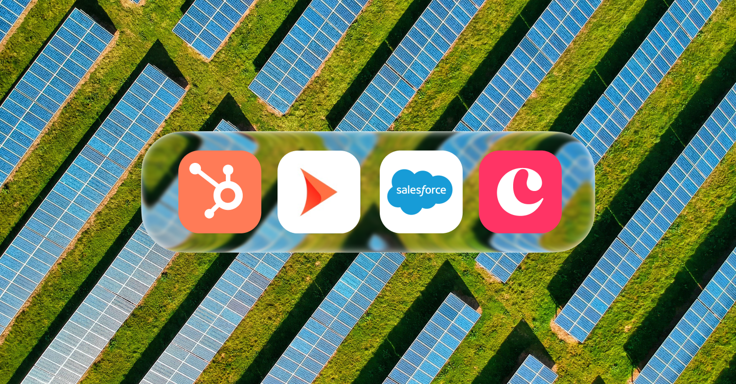 Aerial view of a commercial solar installation with rows of panels in a green field