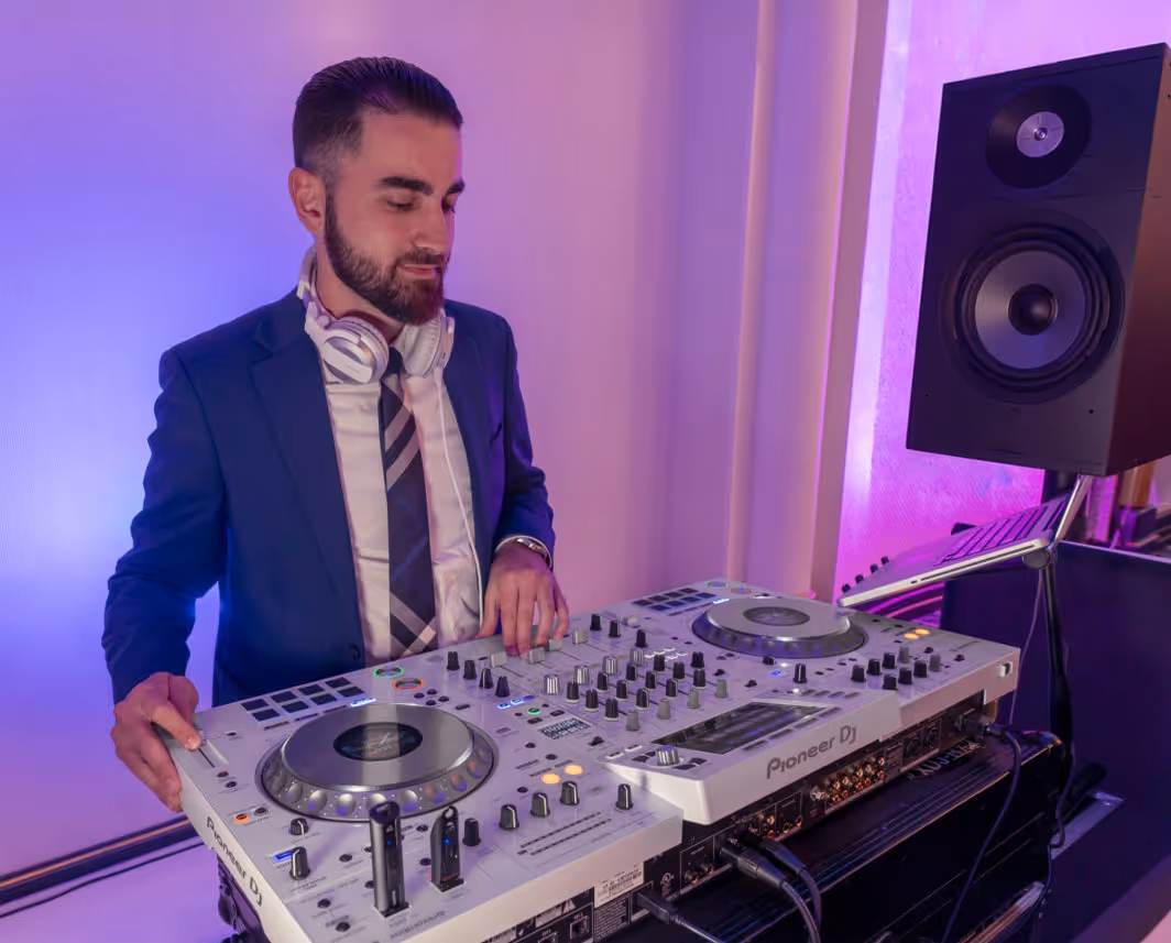 DJ performing at a wedding reception with guests dancing on the illuminated dance floor in Cypress TX.
