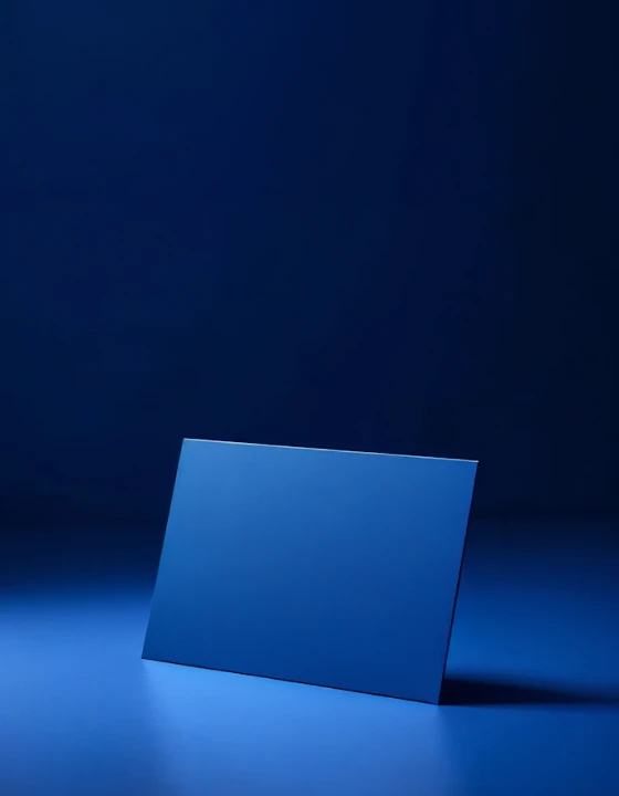 A blue rectangular object placed in a neon-lit room with strong blue lighting.