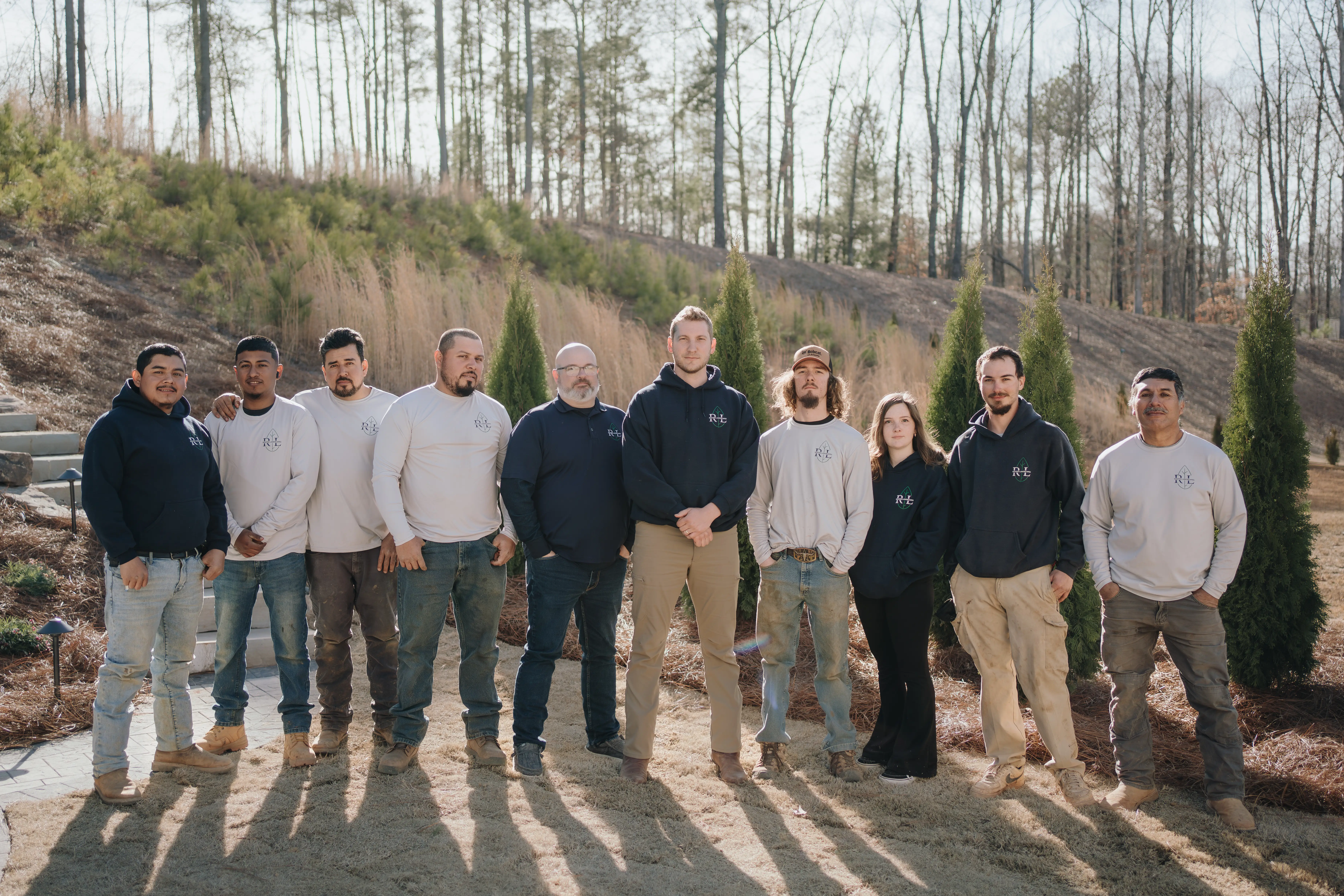 Team photo of Rooted Landscape staff with owner Jerry in the middle