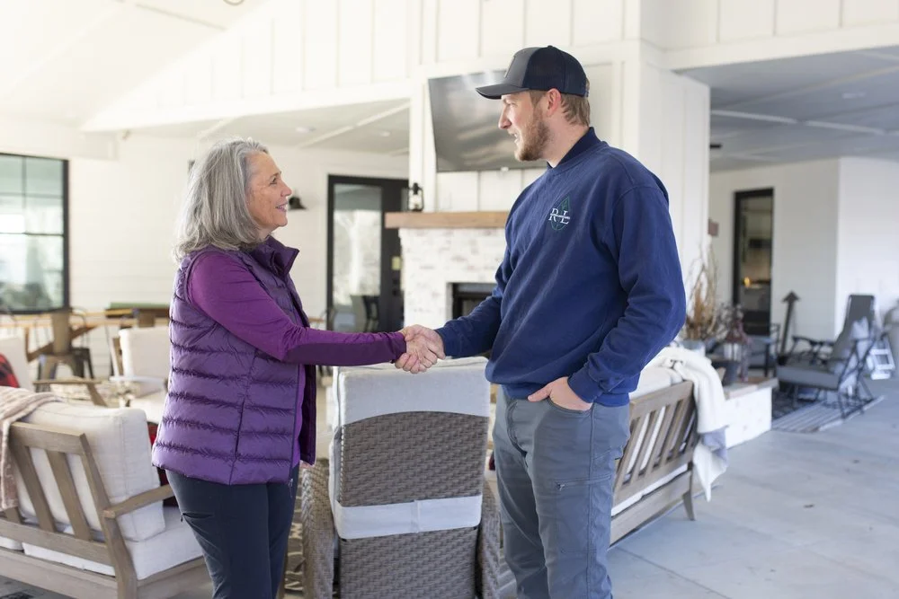 woman shaking hands with man on back porch