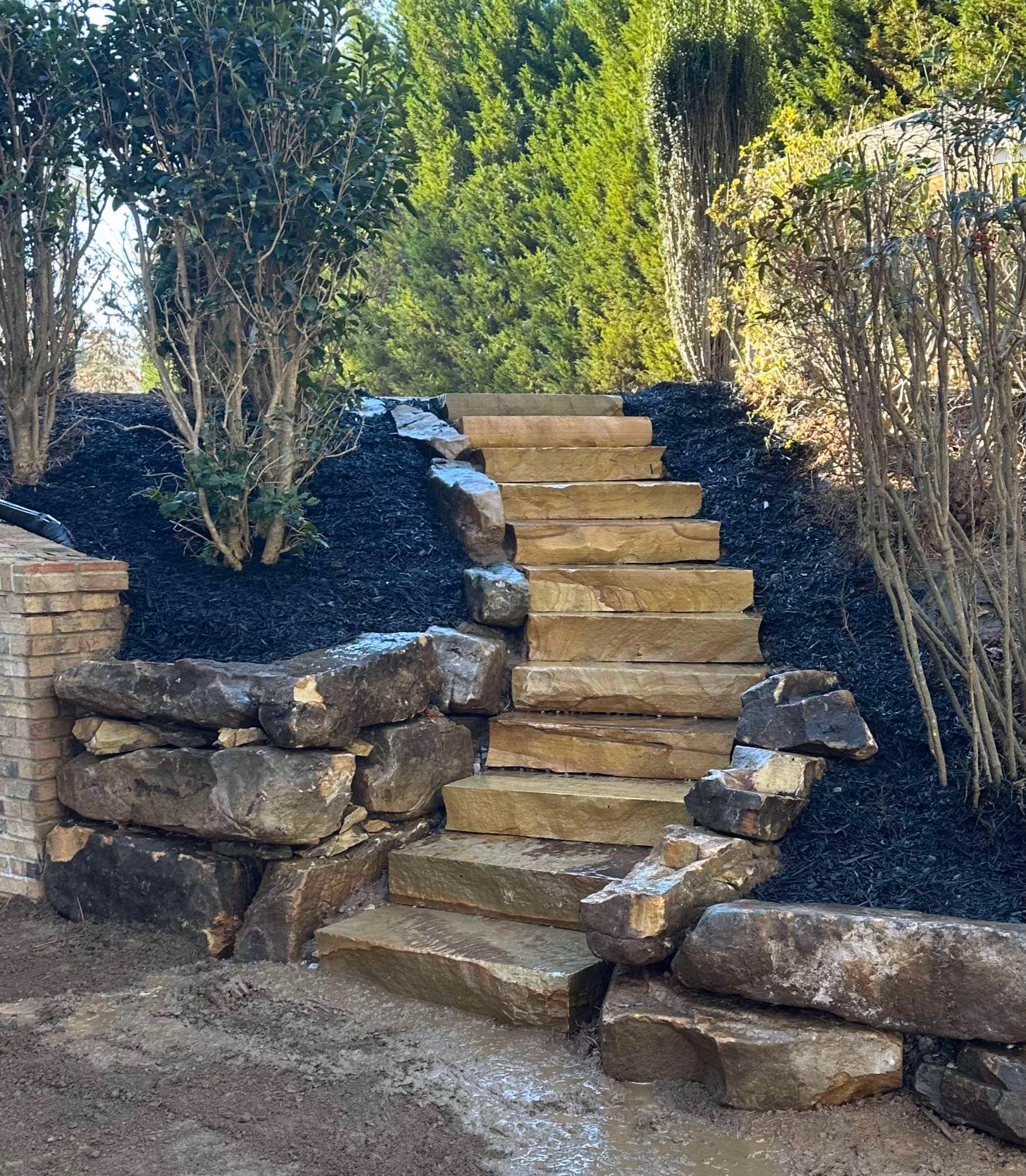 flagstone staircase with boulder wall on the side