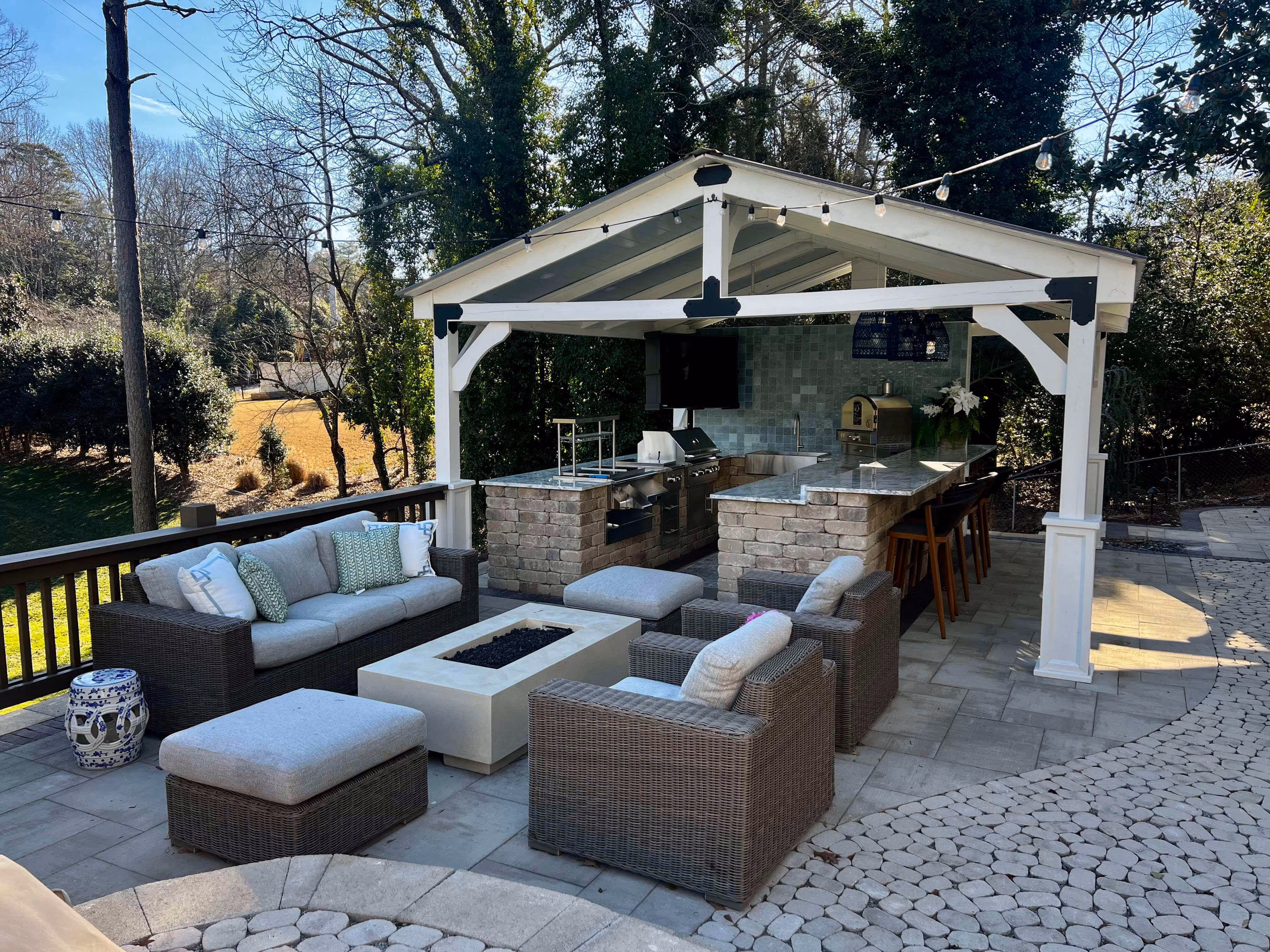 Outdoor patio with furniture and gazebo with outdoor kitchen and grill area