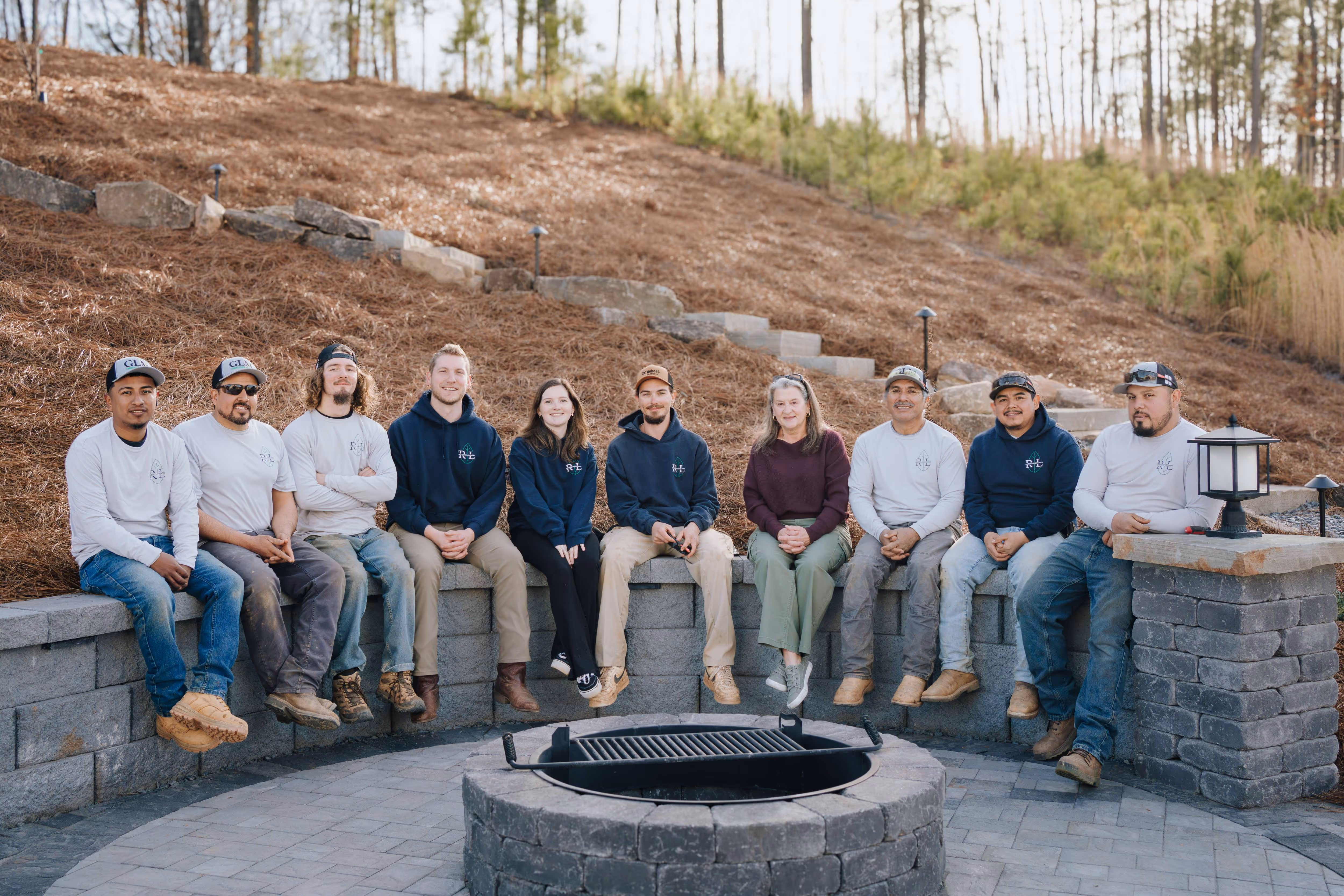 Rooted team sitting with client in fire pit area