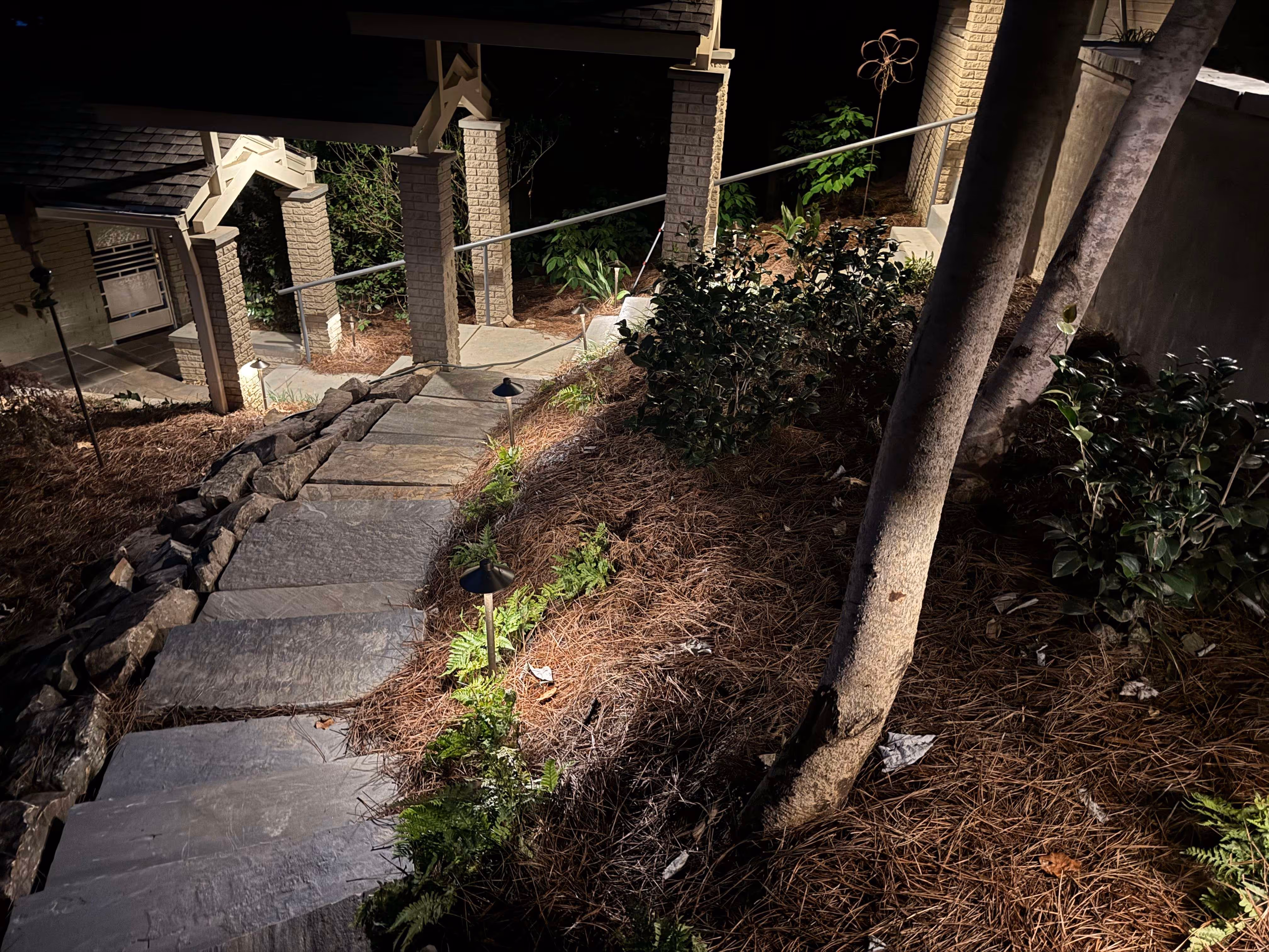 flagstone patio at night well lit by outdoor lighting