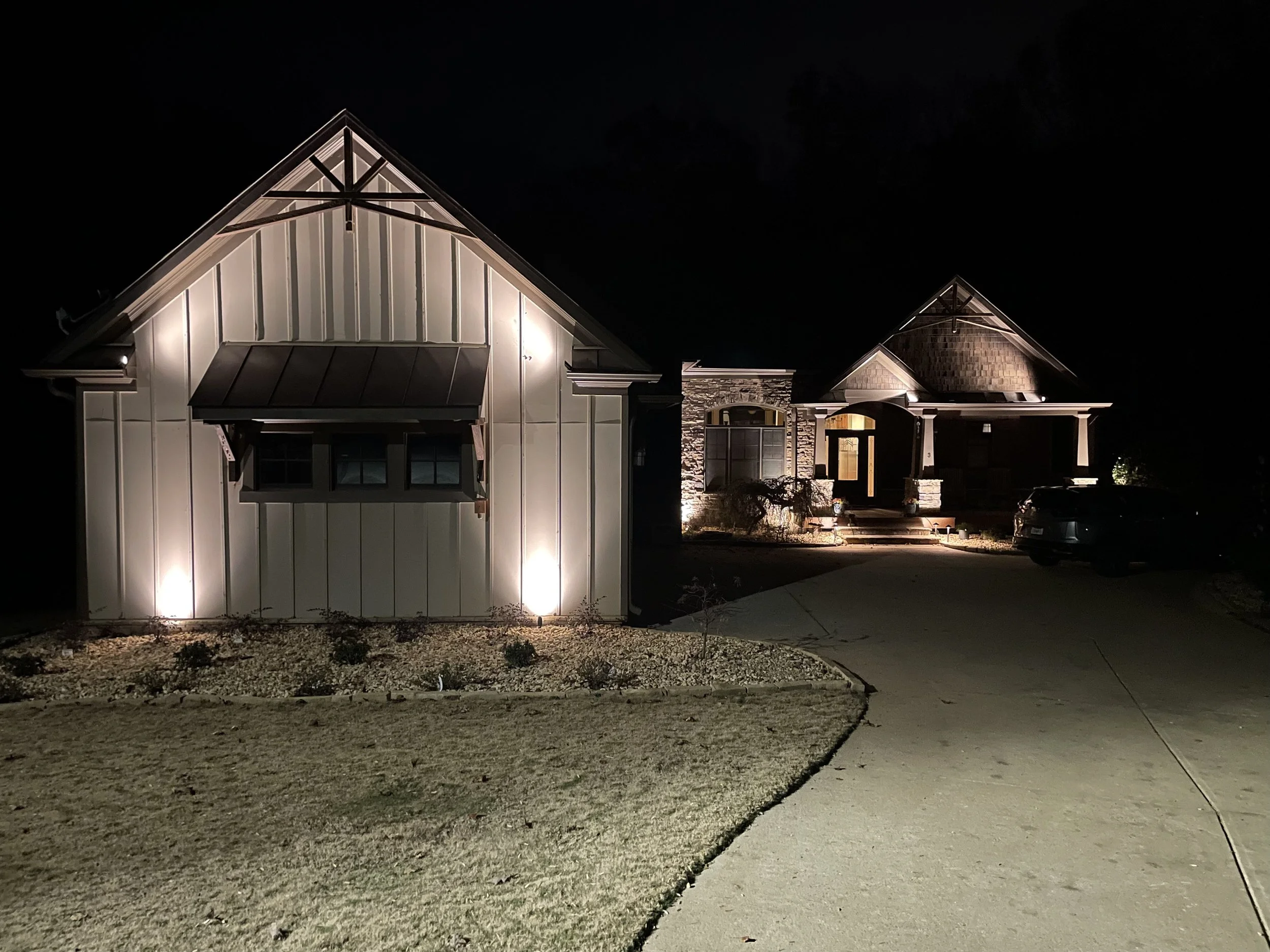 large home at night well lit by home lighting