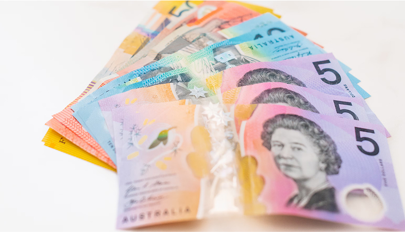 Fanned Australian banknotes in various colors, with a $5 note showing Queen Elizabeth II in front.