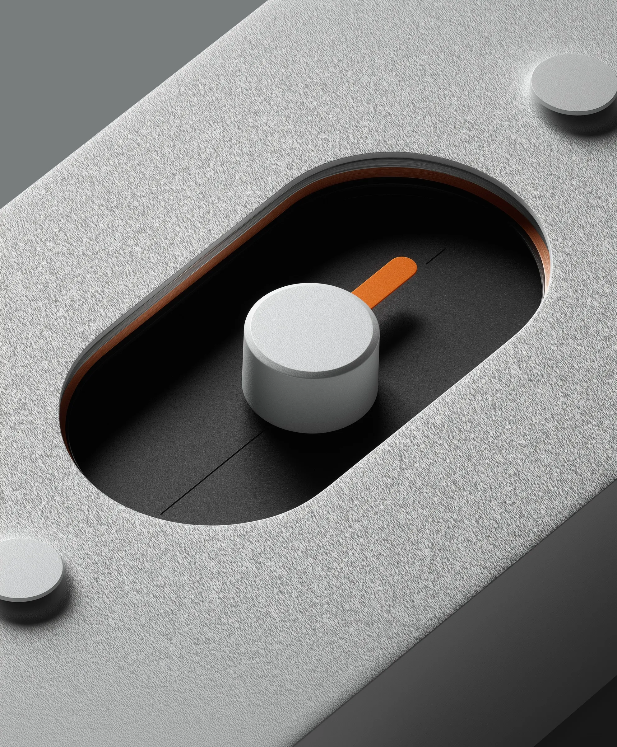Close-up of a modern gray control knob with an orange indicator on a black recessed panel.