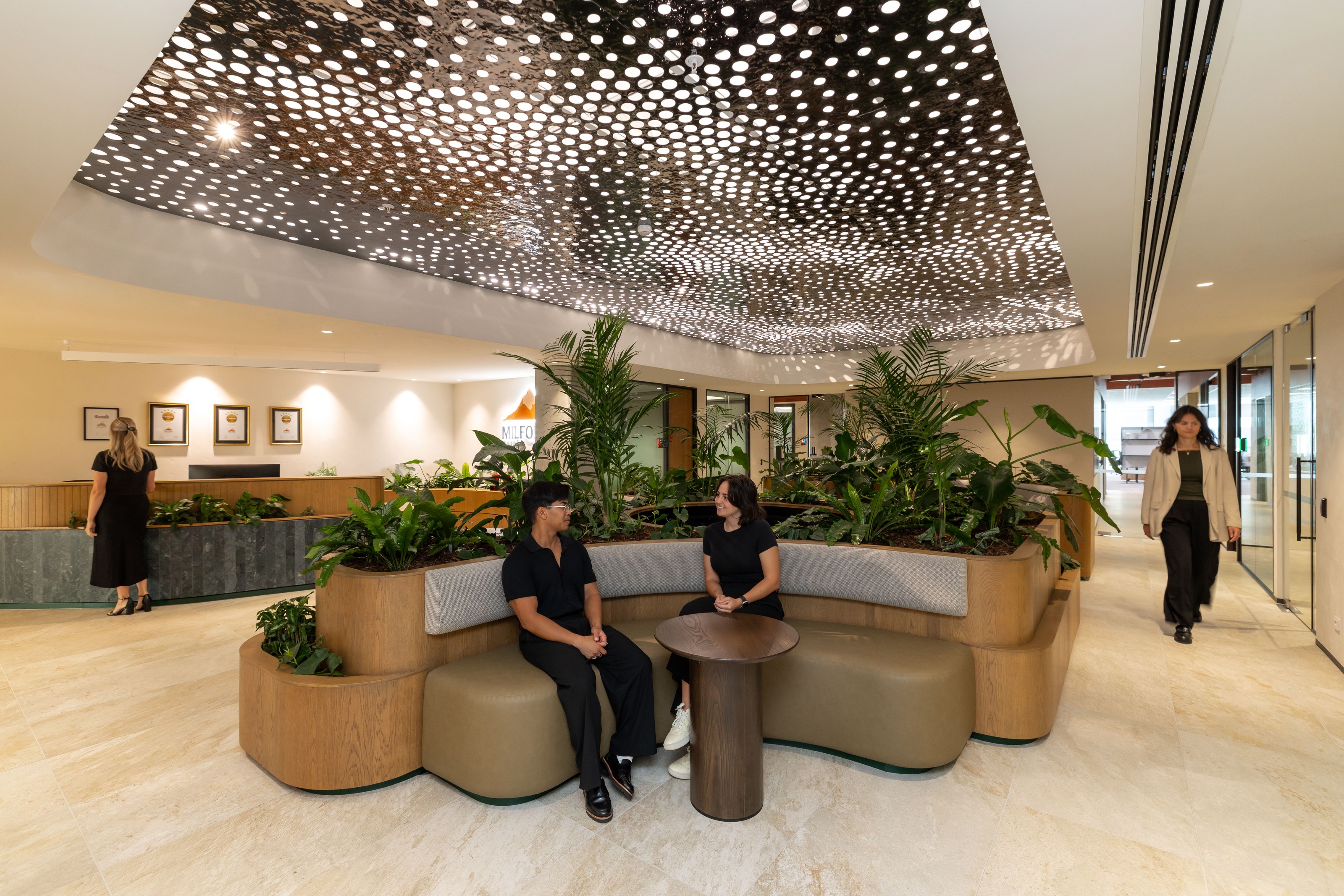 Open-plan office with indoor planter boxes and lush greenery — GreenAir plant hire for workspaces