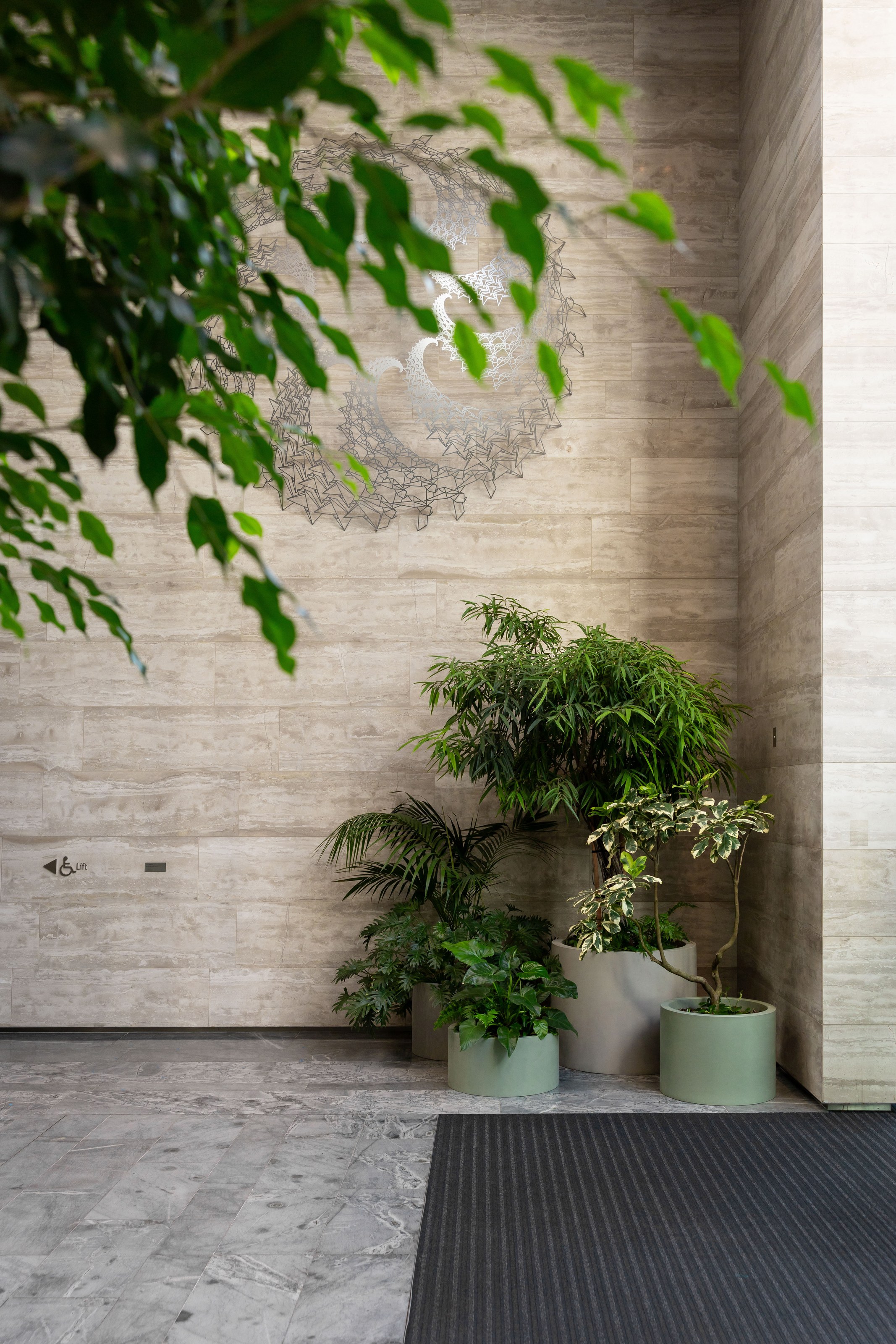 GreenAir indoor plant installation at ANZ Centre Auckland featuring lush tropical greenery transforming a modern corporate office reception area