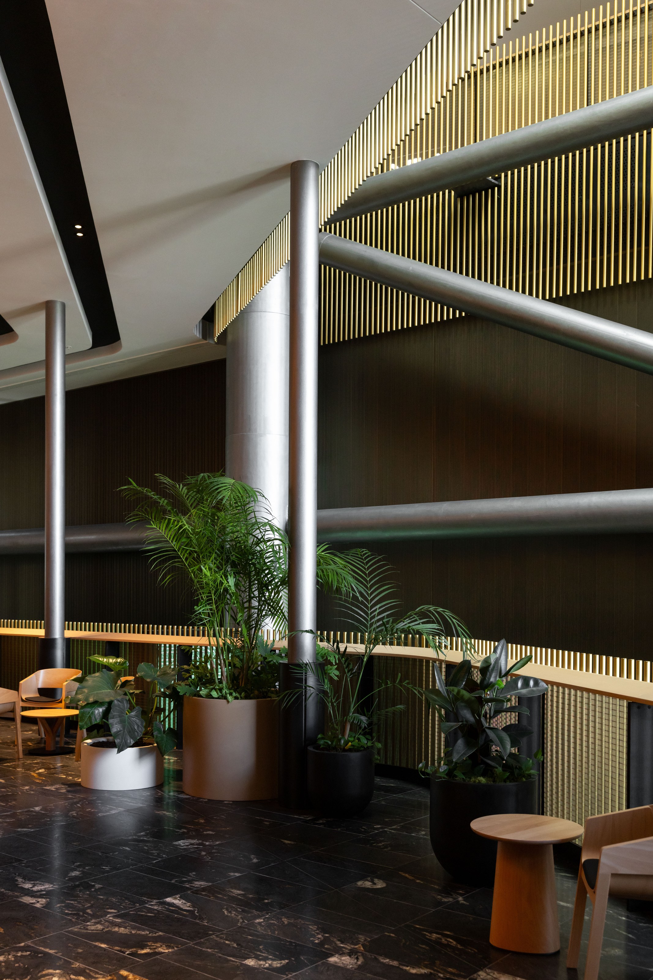 GreenAir indoor plants framing the NZICC Auckland entrance with structural columns and lush tropical greenery