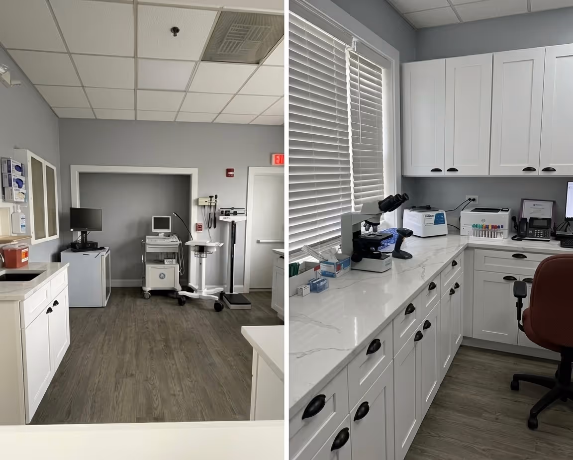 Medical office reception area with a counter window, chair, trash can, and open door to a room with shower.