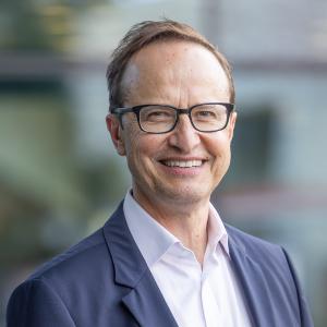 Professor Chris Karapetis smiling directly at the camera
