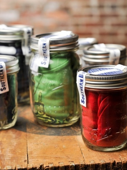 Clothing items in a jar is definitely recyclable and eco friendly. Not maybe suited for postal boxes.