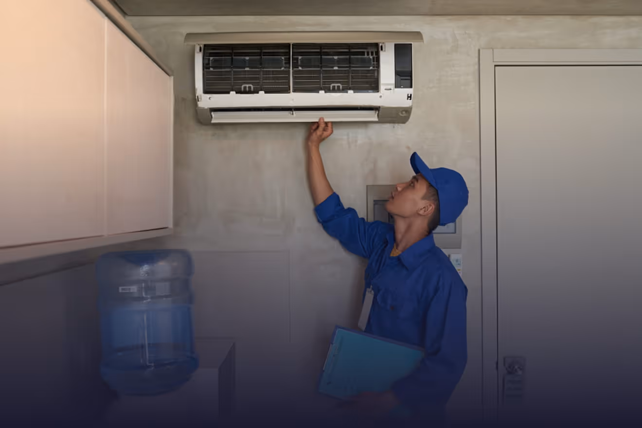 HVAC technician repairing wall mounted air conditioning unit in Bakersfield CA