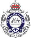 Emblem of the Australian Federal Police featuring a crown, stars, and a central badge with a kangaroo and emu.
